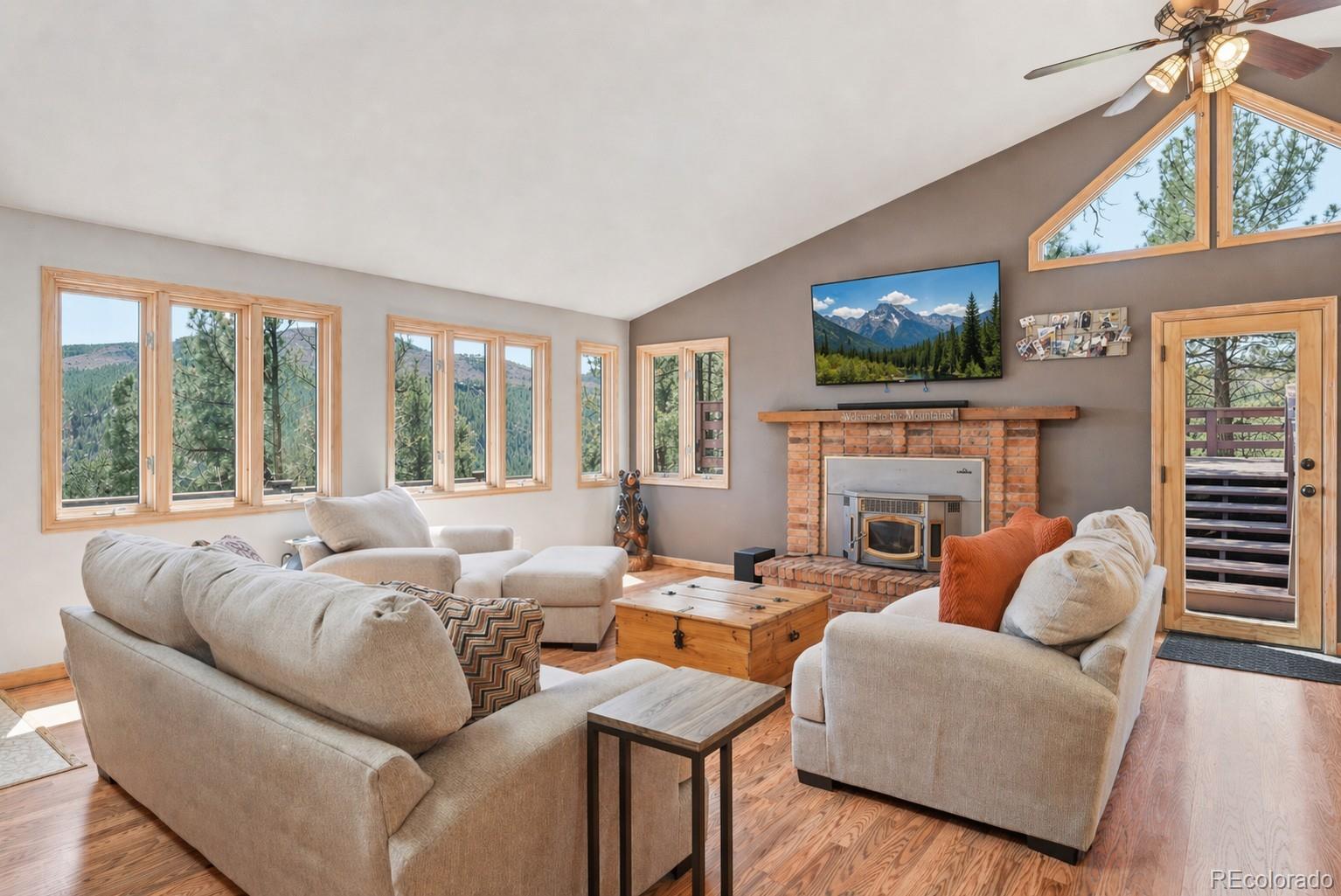 16687 Ouray Road West Pine, CO 80470 - Photo 4 of 49 a living room with furniture a fireplace and a flat screen tv