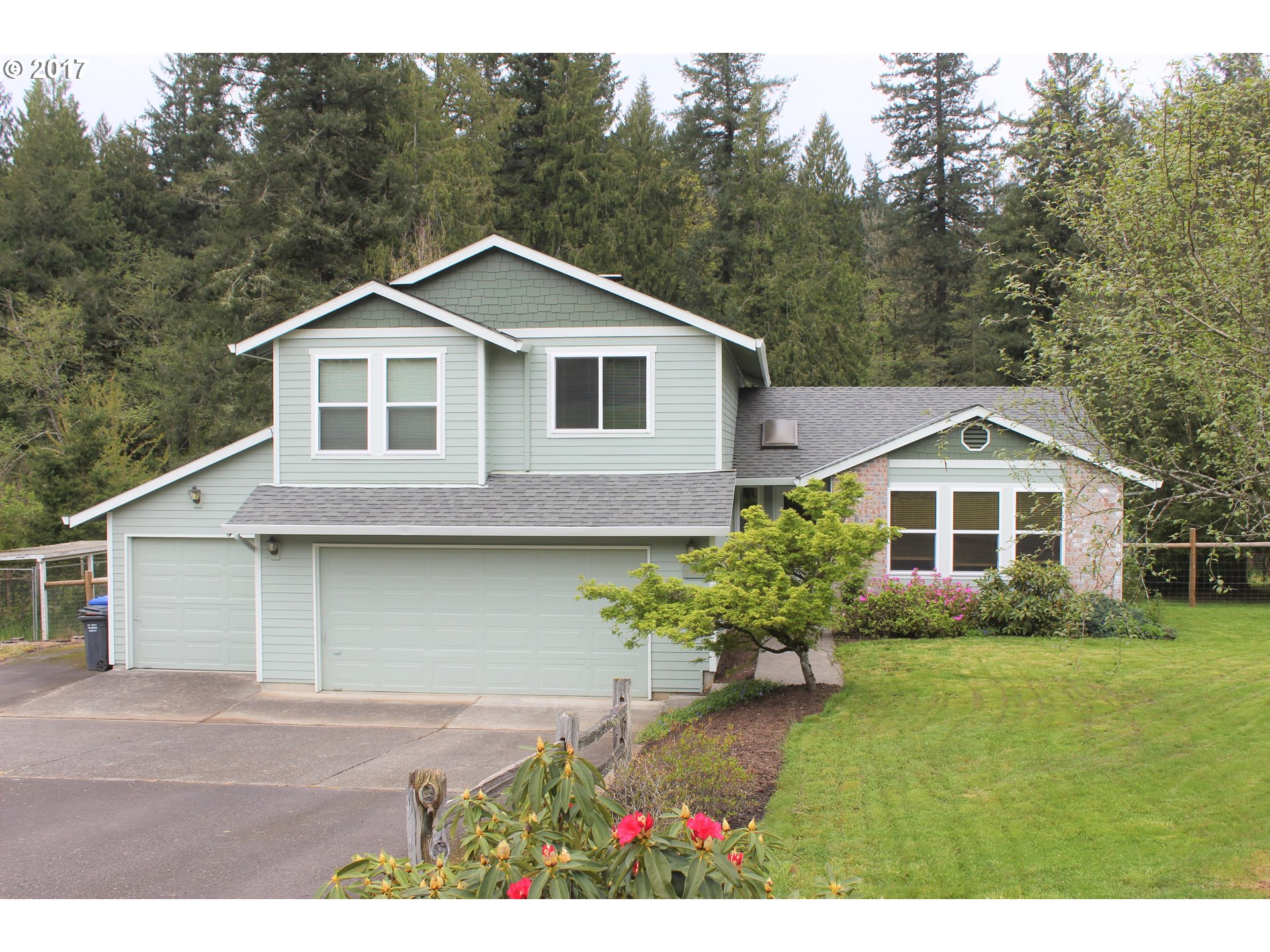 19637 Southeast Heuke Road Damascus, OR 97089 - Photo 1 of 14 a front view of a house with a yard and garage
