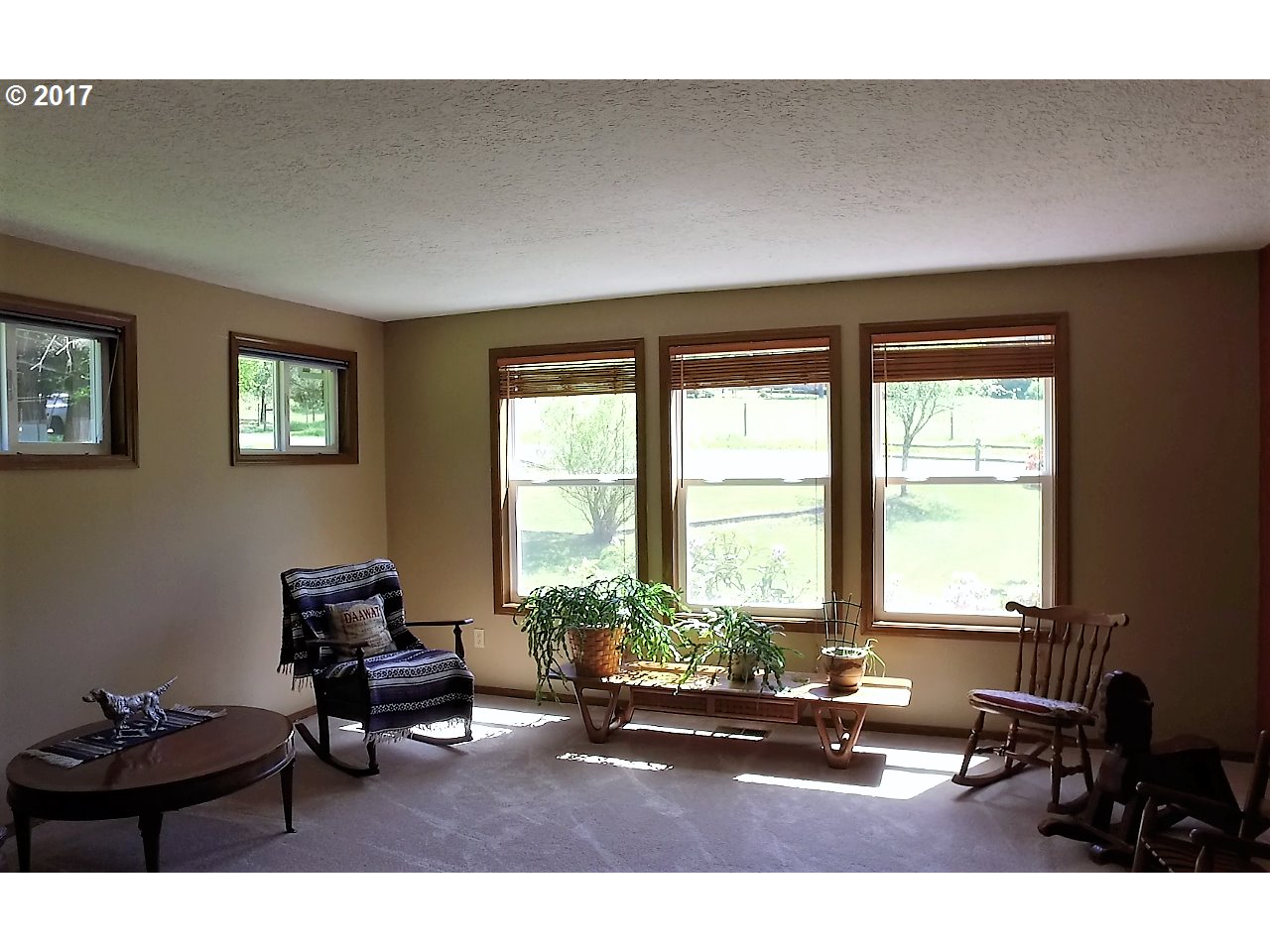 19637 Southeast Heuke Road Damascus, OR 97089 - Photo 3 of 14 a living room with furniture and floor to ceiling windows