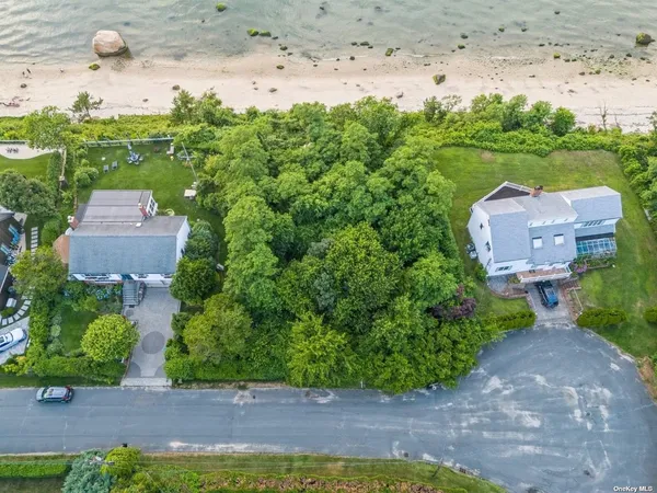 an aerial view of a house with garden space and street view