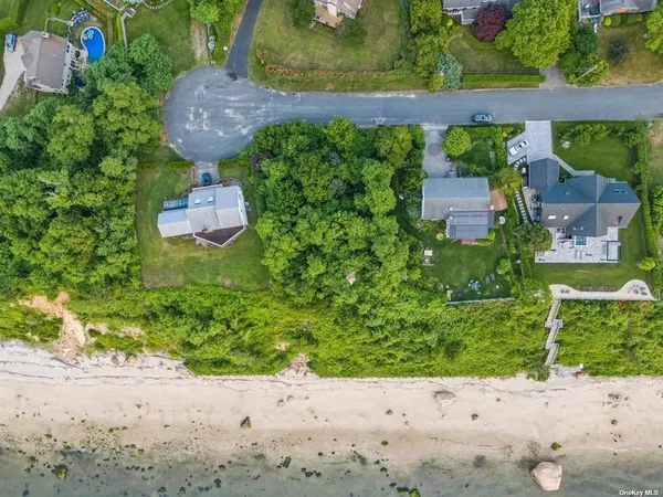 an aerial view of a house with a yard basket ball court and outdoor seating