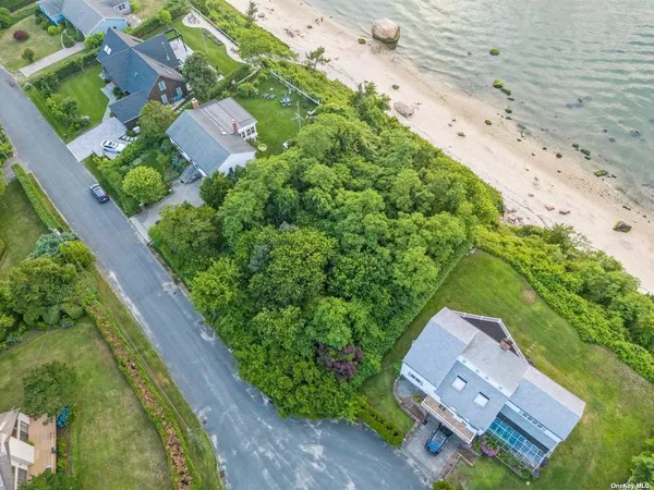 an aerial view of ocean with residential house with outdoor space