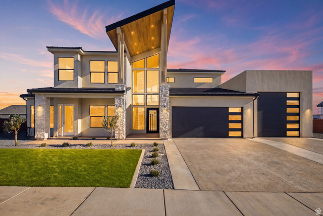 3011 East Rimrunner Drive, Unit 302 St. George, UT 84790 - Photo 4 of 45 Contemporary house with an attached garage, stone siding, concrete driveway, and stucco siding