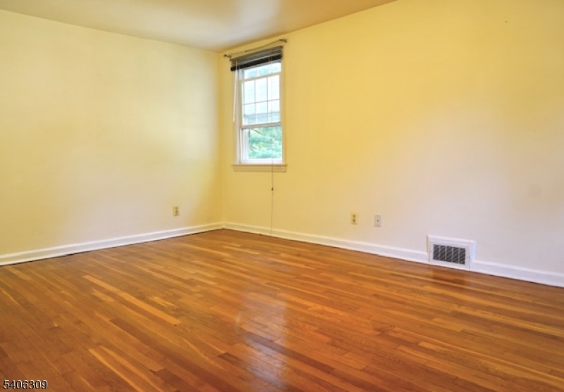 17 Wellington Road Livingston, NJ 07039 - Photo 12 of 20 an empty room with wooden floor and windows