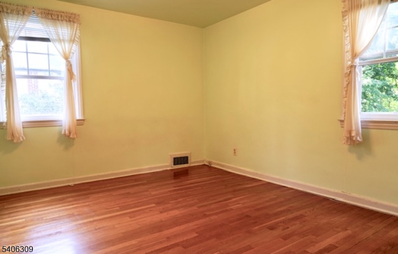 17 Wellington Road Livingston, NJ 07039 - Photo 14 of 20 an empty room with wooden floor and windows