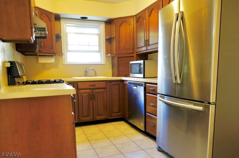 17 Wellington Road Livingston, NJ 07039 - Photo 5 of 20 a kitchen with stainless steel appliances granite countertop a refrigerator and a sink