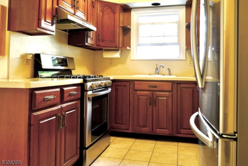17 Wellington Road Livingston, NJ 07039 - Photo 6 of 20 a kitchen with stainless steel appliances granite countertop wooden cabinets a sink and a window