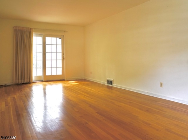 17 Wellington Road Livingston, NJ 07039 - Photo 8 of 20 an empty room with wooden floor and windows