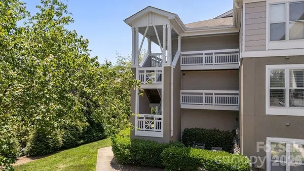 a front view of a house with plants
