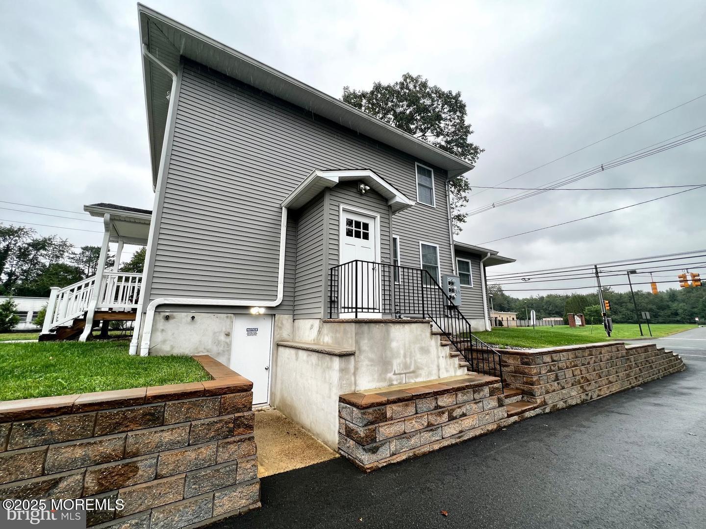 1253 Yardville Allentown Road, Unit 2 Allentown, NJ 08501 - Photo 2 of 12 a front view of a house with a yard table and chairs
