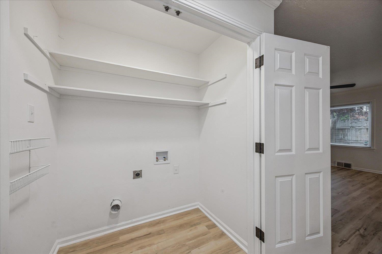 6137 Quince Road Memphis, TN 38119 - Photo 12 of 19 Laundry area with light wood-style flooring, washer hookup, and electric dryer hookup