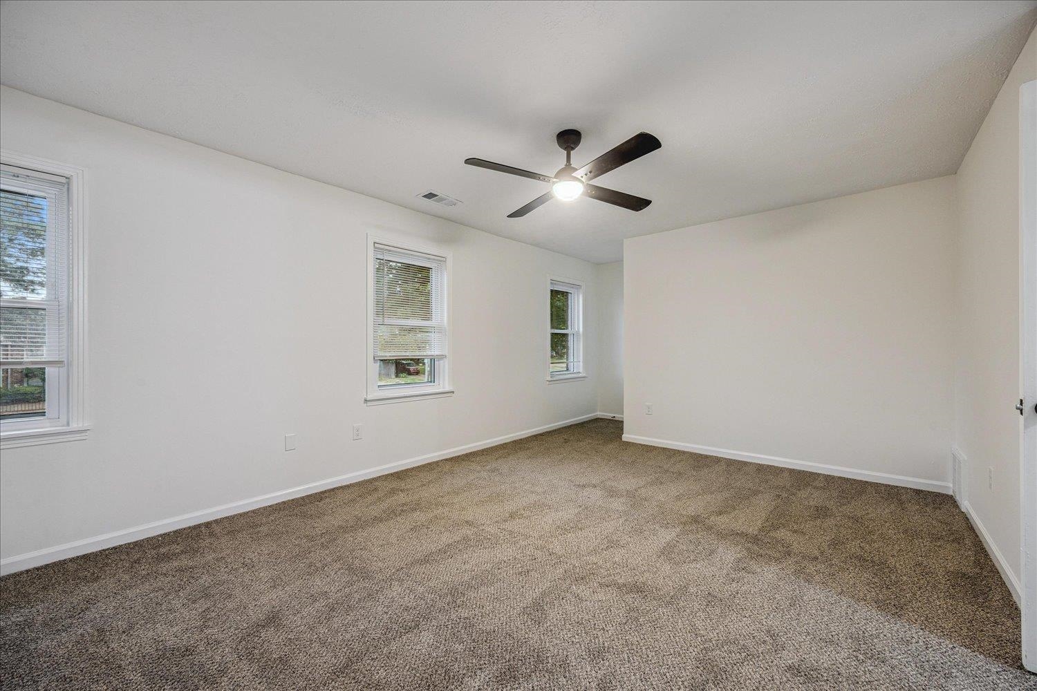 6137 Quince Road Memphis, TN 38119 - Photo 14 of 19 Carpeted spare room featuring baseboards and a ceiling fan