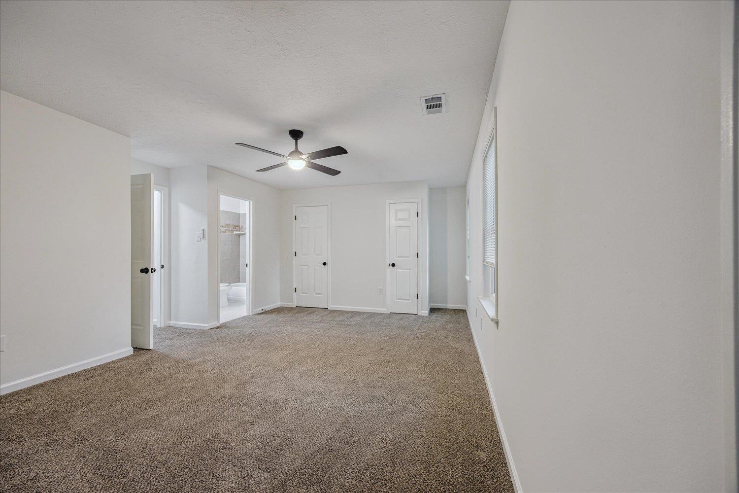 6137 Quince Road Memphis, TN 38119 - Photo 15 of 19 Empty room with light colored carpet and a ceiling fan