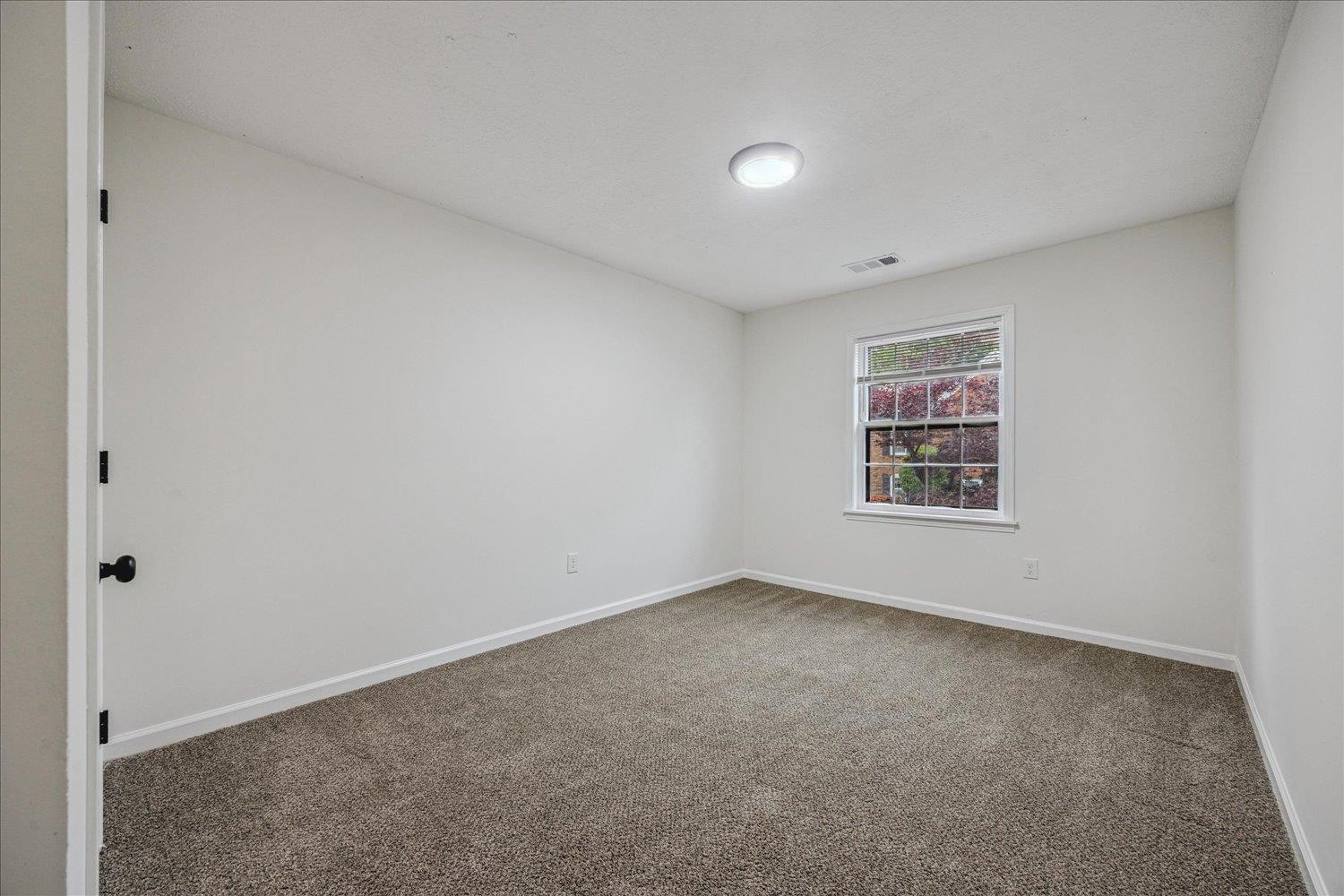 6137 Quince Road Memphis, TN 38119 - Photo 17 of 19 Empty room with dark carpet and baseboards