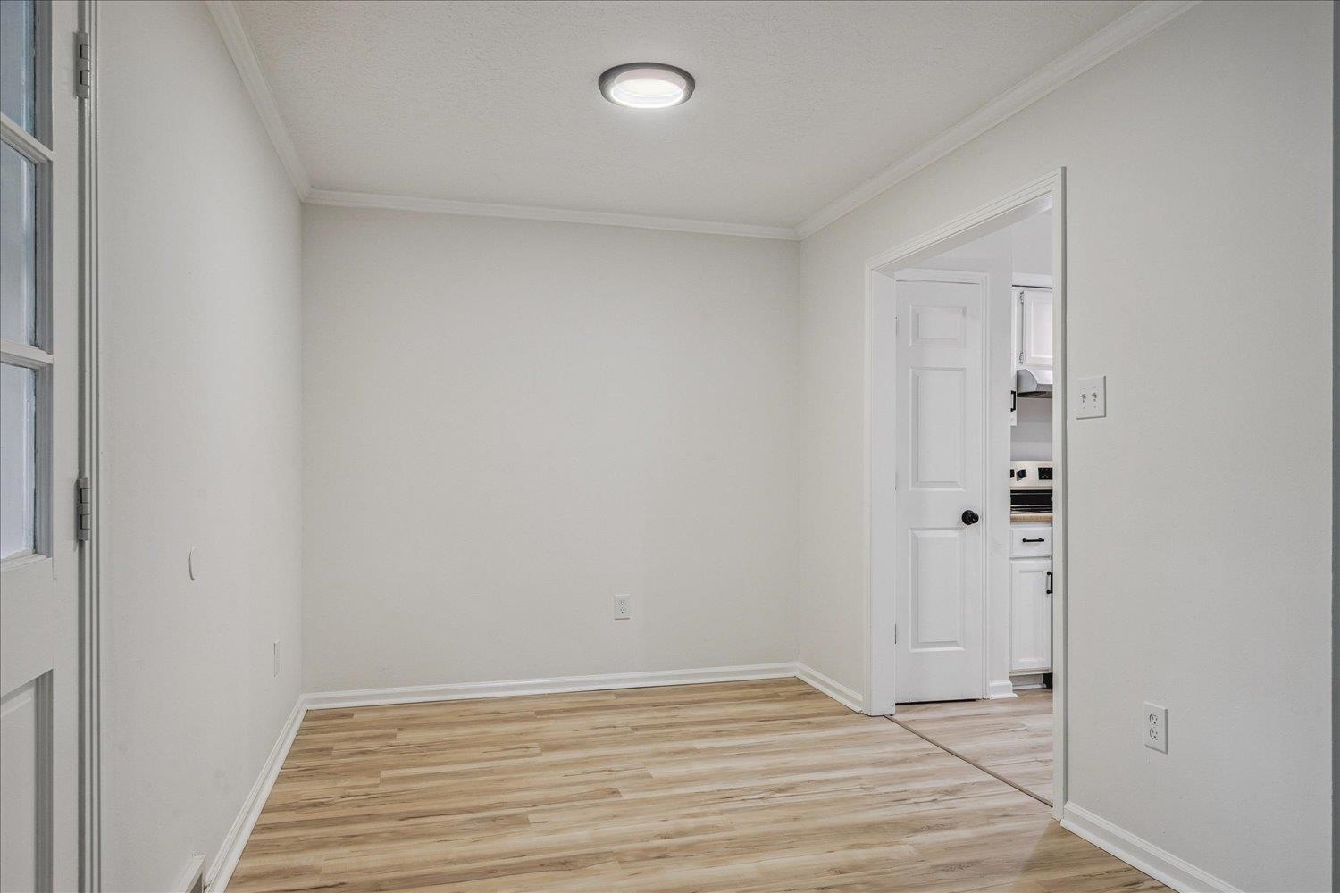 6137 Quince Road Memphis, TN 38119 - Photo 6 of 19 Unfurnished room with light wood finished floors and crown molding