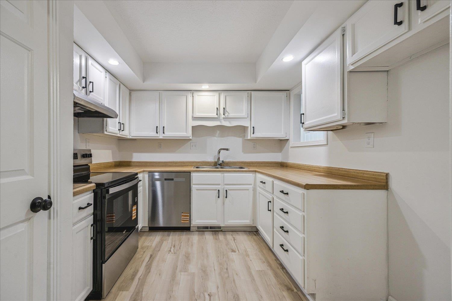 6137 Quince Road Memphis, TN 38119 - Photo 7 of 19 Kitchen featuring white cabinetry, recessed lighting, stainless steel appliances, light wood-style flooring, and light countertops