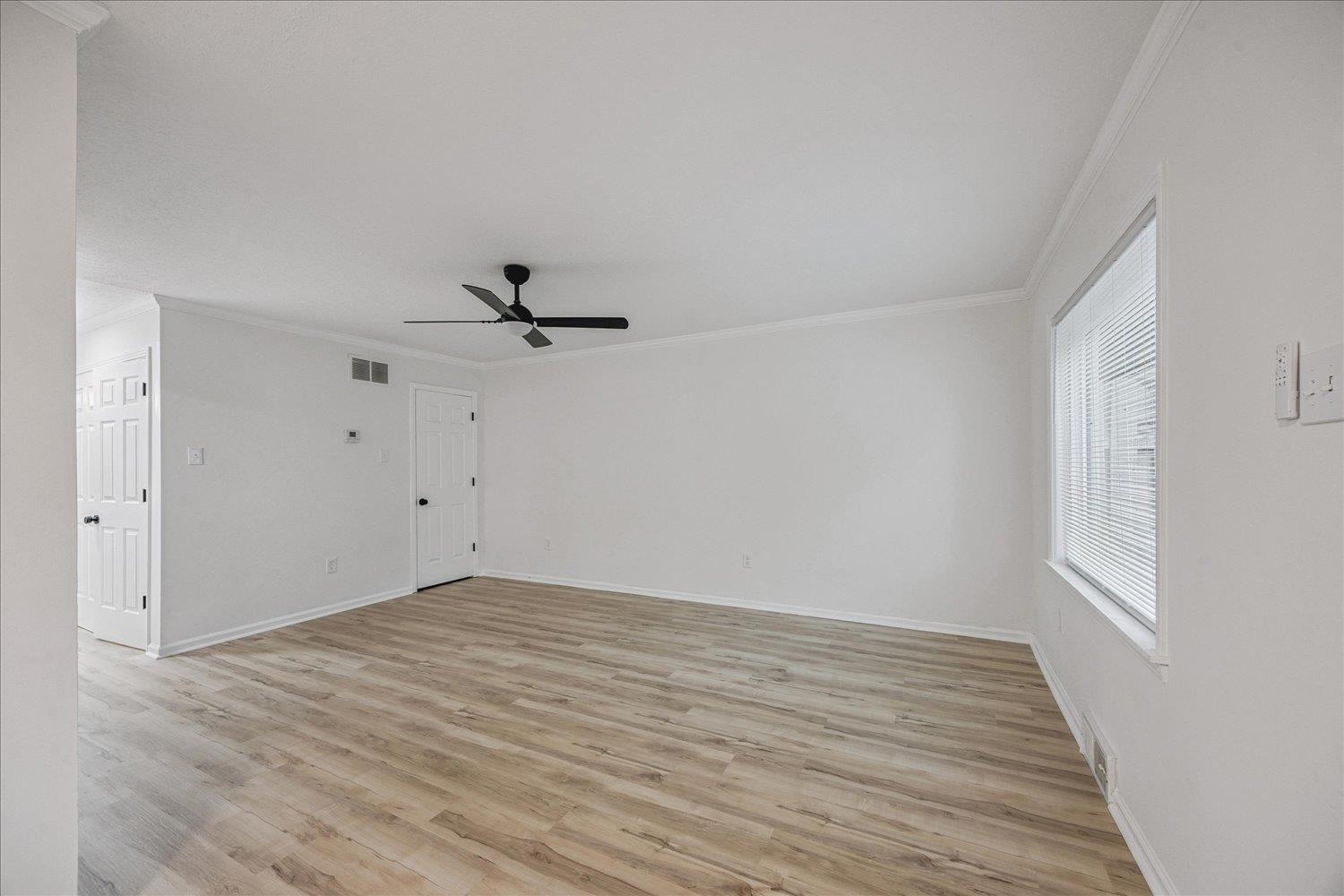 6137 Quince Road Memphis, TN 38119 - Photo 9 of 19 Unfurnished room featuring ornamental molding, light wood-style flooring, and ceiling fan