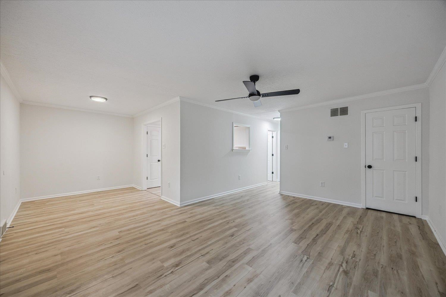 6137 Quince Road Memphis, TN 38119 - Photo 10 of 19 Unfurnished room featuring ceiling fan, ornamental molding, and light wood-style flooring