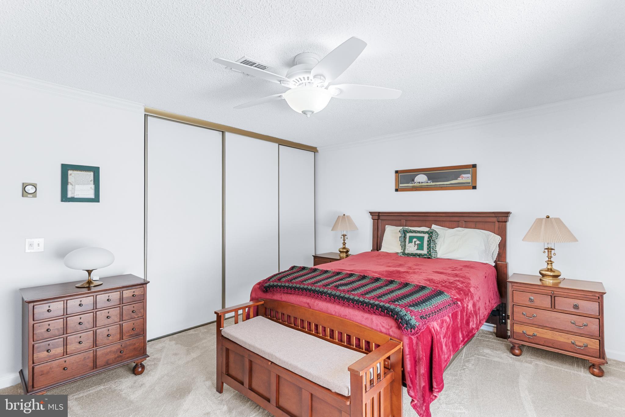 15400 Short Ridge Court, Unit 42A Silver Spring, MD 20906 - Photo 14 of 24 a bedroom with a bed and a chandelier