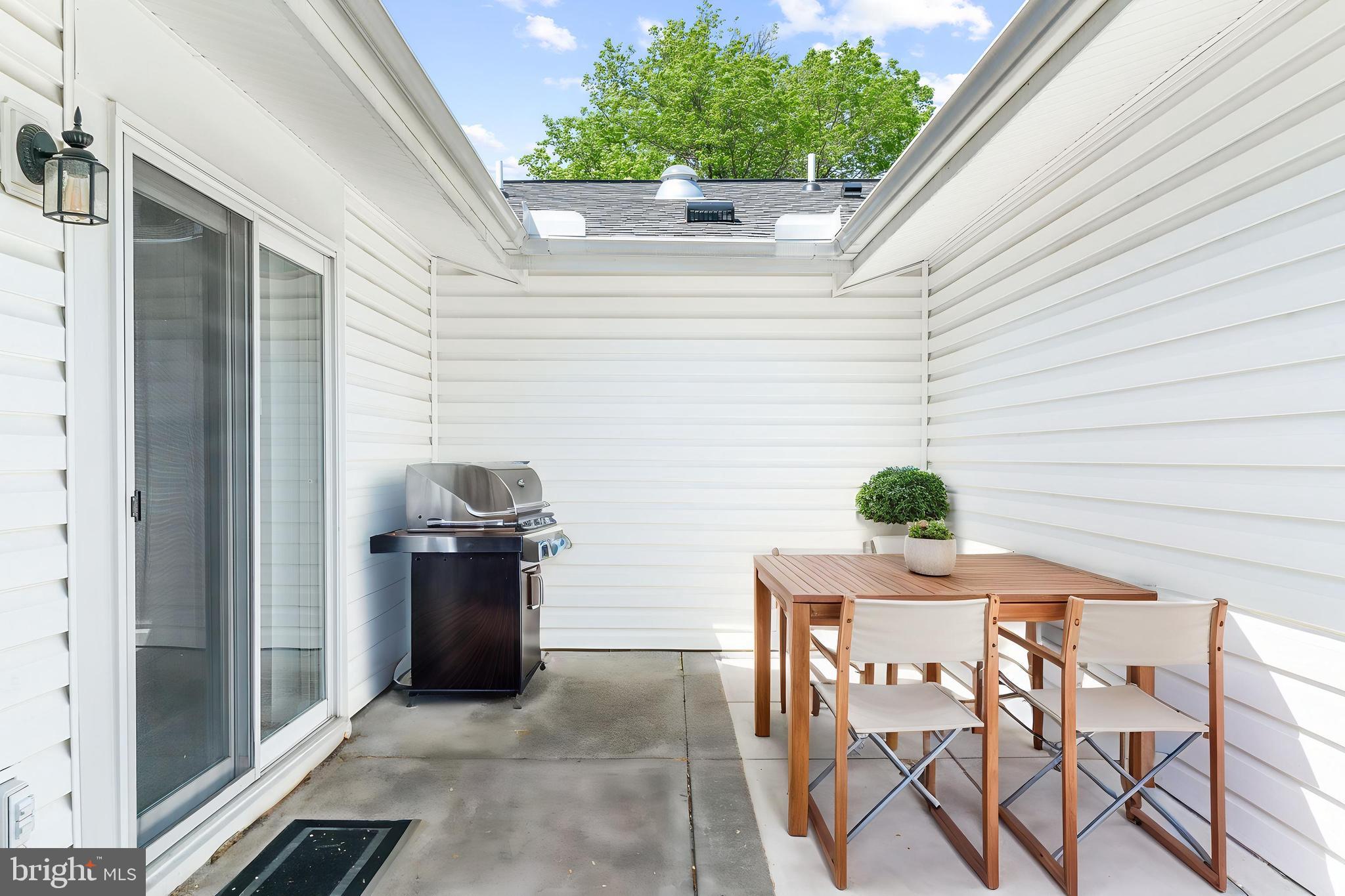 15400 Short Ridge Court, Unit 42A Silver Spring, MD 20906 - Photo 23 of 24 a view of backyard with a grill and potted plants