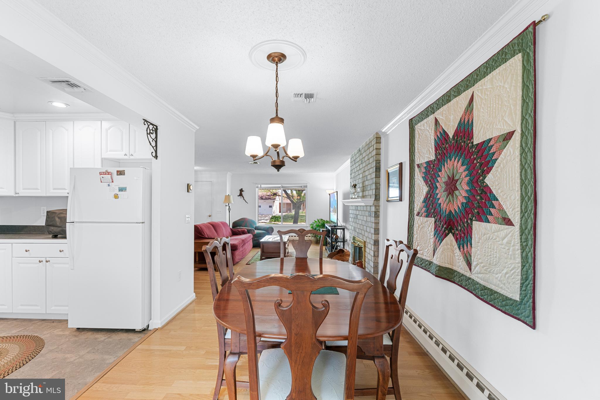 15400 Short Ridge Court, Unit 42A Silver Spring, MD 20906 - Photo 7 of 24 a view of a dining room with furniture and chandelier