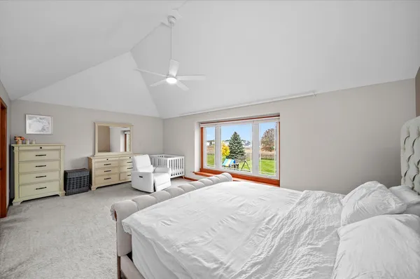 a bedroom with furniture and a large window