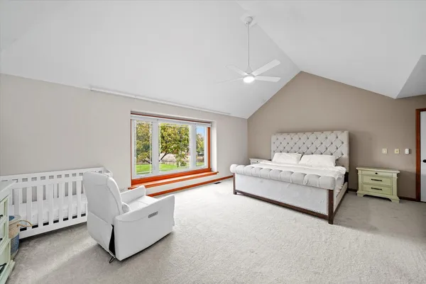 a spacious bedroom with a bed and a couch
