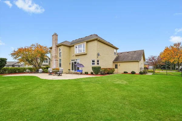 a view of a house with a yard and sitting area