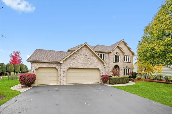 a front view of a house with a yard and garage