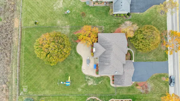 an aerial view of a house with a yard basket ball court and outdoor seating