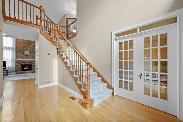 a view of entryway and hall with wooden floor