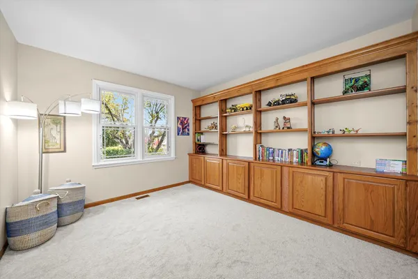 a big room with windows and cabinet