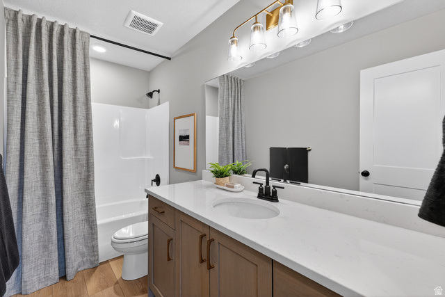2841 West 2705 North, Unit 69 Ogden, UT 84404 - Photo 23 of 31 Modern bathroom featuring a wood-finish vanity with a single basin sink and white countertop