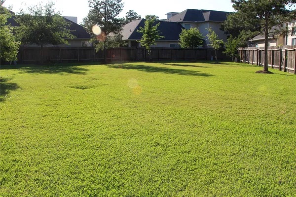 a view of swimming pool and deck in the backyard