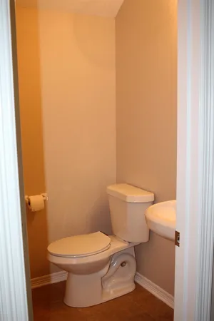 a white toilet sitting next to a shower