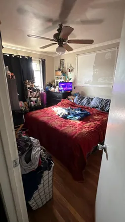 a bed sitting in a room next to a window