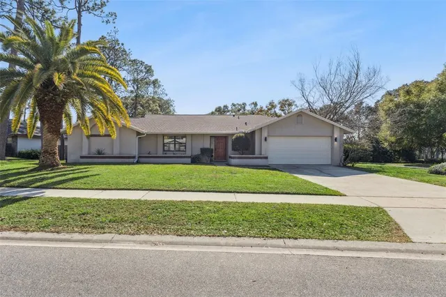 a front view of house with yard and green space