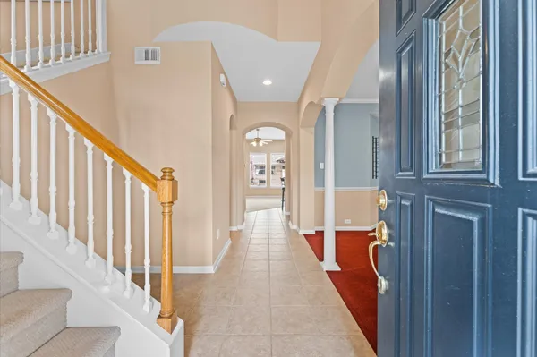a view of a hallway with wooden floor and staircase