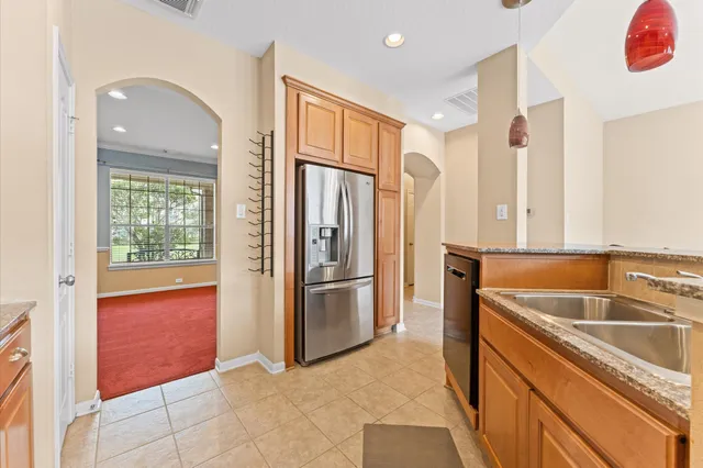 a kitchen with a refrigerator sink and cabinets
