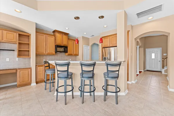 a view of a dining room with furniture and a kitchen