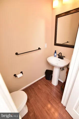 a bathroom with a sink mirror and toilet