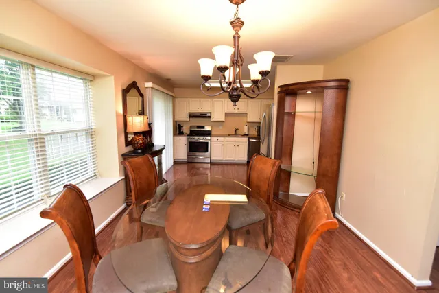 a view of a dining room with furniture window and wooden floor