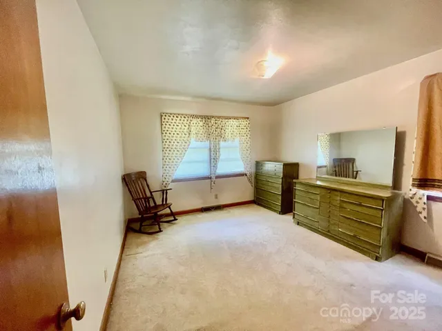 a view of a livingroom with furniture and a window