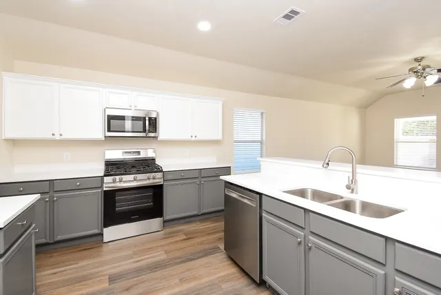 a kitchen with a stove and a microwave