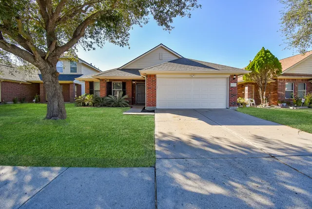 a view of front door with potted plants