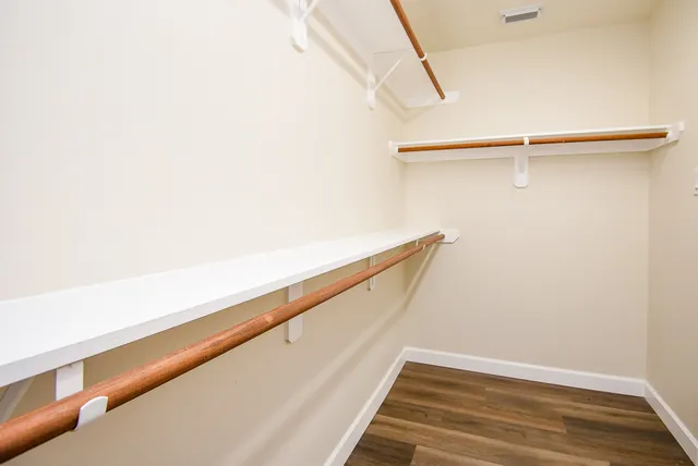 an empty room with a window and a ceiling fan