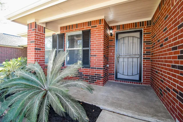 a dining room with furniture a chandelier and wooden floor