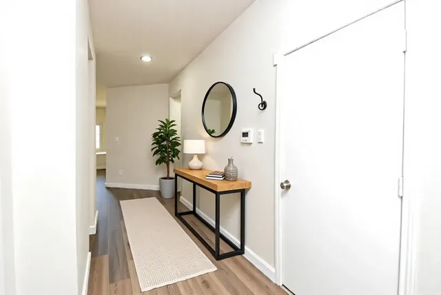 a kitchen with a dining table chairs and view living room