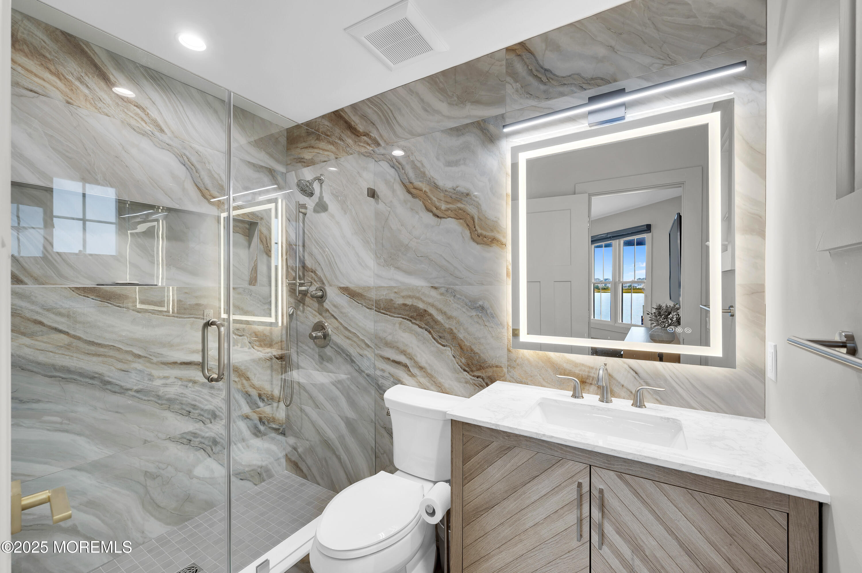 28 Harborside Drive East Seaside Heights, NJ 08751 - Photo 23 of 34 a bathroom with a sink toilet vanity and shower