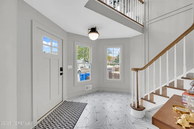 a view of an entryway with wooden floor